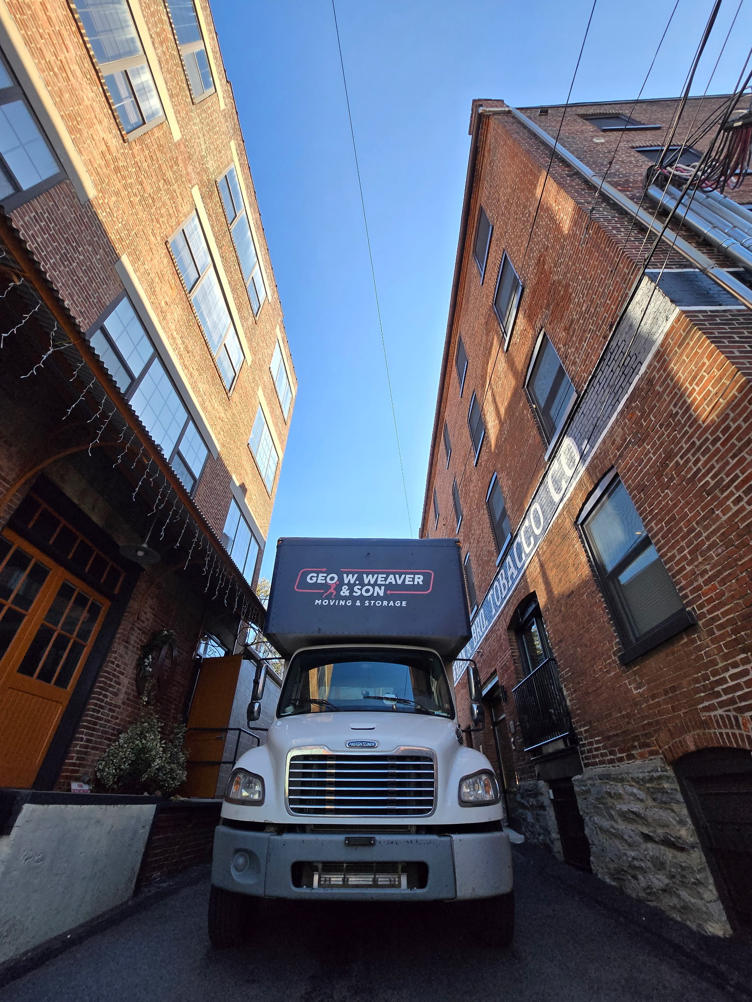 A photo of a Geo. W. Weaver & Son Truck on a street in Lancaster, PA moving someone to Lancaster
